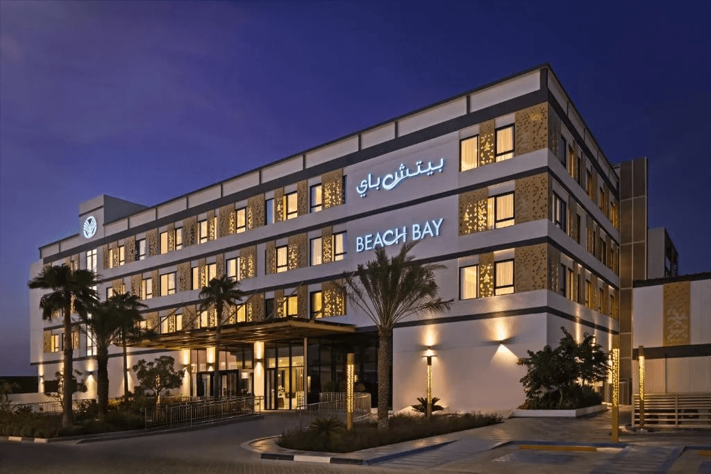 Beach Bay Hotel building at dusk with illuminated signage